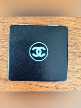 Black & White Chanel Metal Bifold Dual Magnification Mirror with ‘CC’ Branding.